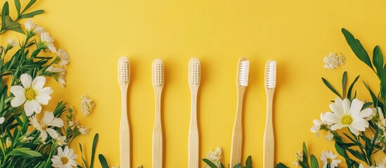 Aufkleber - Four bamboo toothbrushes on a yellow backdrop surrounded by a floral frame Eco friendly. with copy space image. Place for adding text or design
