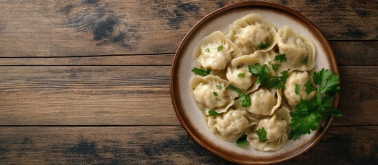 Fototapete - Delicious homemade meat dumplings made from wholemeal flour or Russian pelmeni garnished with fresh parsley on a plate on a wooden table copyspace top view