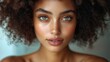 © Mohammed - Close-up portrait of a young woman with beautiful freckled skin and a vibrant afro. Her striking green eyes and warm complexion create a captivating image.
