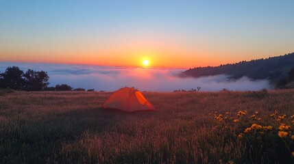 Wall Mural - Stunning sunset over misty valley with a camping site and colorful sky at dusk