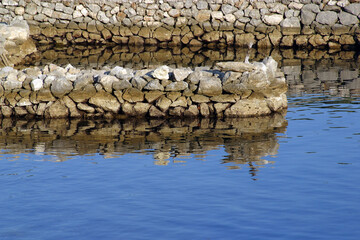 A small stone port and pier in Simuni, island of Pag, Croatia