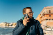 © Bohdan - Young man talking by mobile phone