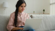 © Yuliia - Female Arabian woman girl typing laptop at home working in quarantine Indian businesswoman student studying online e-learning business internet chatting use computer app make order website freelance