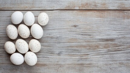 Poster - White speckled quail eggs beautifully arranged on rustic wooden table background for culinary or decorative use
