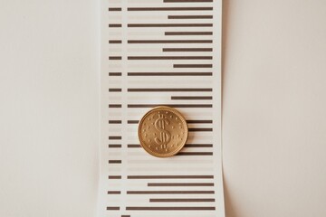 Aufkleber - A gold coin rests on a financial statement, symbolizing investment, budgeting, or financial planning.