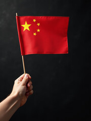 Poster - Image Of A Hand Holding A Chinese Flag On A Textured Black Background With Plenty Of Space For Copying Text. 00002