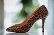 © Ева Поликарпова - A pair of luxurious leopard print high heels on a table, great for fashion and beauty shots