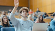 © Ariba - In a modern university setting, a Hispanic student uses a laptop and raises his hand to pose a question, part of a multiethnic group of bright and engaged learners.