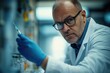© SERHII - Scientist in lab holding syringe with focus. Science advances through research and innovation.