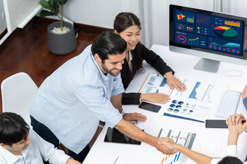 Leinwandbilder - Happy office worker and project manager shake hand in meeting room after successfully achieving business task on time and on schedule. Project management tracking software for business success.Prudent
