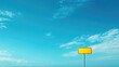 © ArtificialHorizons - Vibrant yellow blank sign against a pristine blue sky with scattered clouds ideal for advertising or direction placement concept