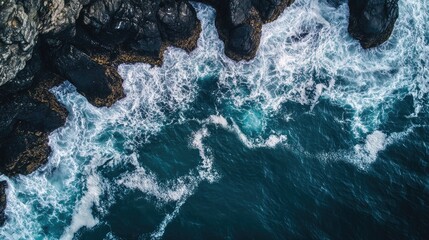 Poster - Aerial View of Turquoise Waves Surging Against Dramatic Rocky Shoreline Ideal for Text Overlay and Creative Designs