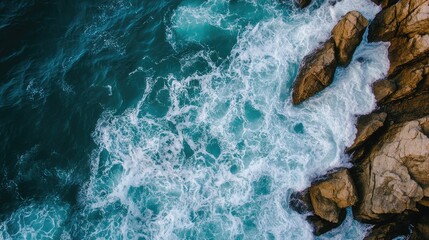 Poster - Aerial View of Turquoise Waves Crashing onto Rugged Rocks Coastal Landscape with Ample Space for Text or Graphic Overlay