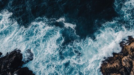 Poster - Aerial View of Ocean Waves Crashing on Rocky Shoreline with Space for Text and Captivating Water Patterns