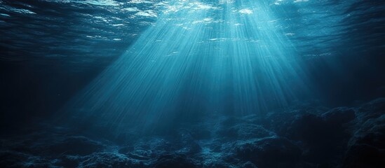 Poster - Abstract dark underwater scene with light rays illuminating deep water with ample copyspace for text or design elements.