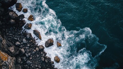 Poster - Aerial view of rocky shoreline with waves crashing and open space for text placement in coastal scenery