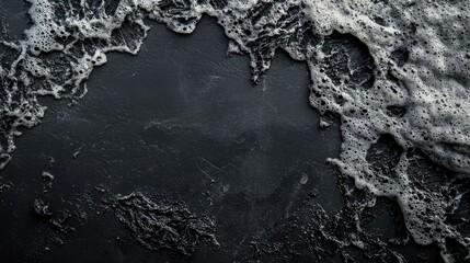 Poster - Aerial view of volcanic ash foam on dark surface creating dramatic texture with space for text or design elements