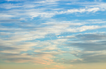 Wall Mural - a beautiful sky tinted by the sun leaving vibrant shades of gold, pink, blue and multicolored. cloud