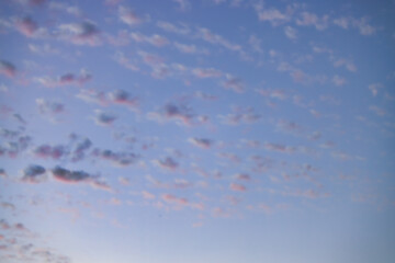 Wall Mural - a beautiful sky tinted by the sun leaving vibrant shades of gold, pink, blue and multicolored. cloud