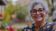 © yevhen89 - Senior Indian woman in sari with joyful smile outdoors. Warm and welcoming atmosphere. Copy space