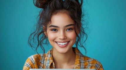 Wall Mural - Happy young woman smiling at camera.