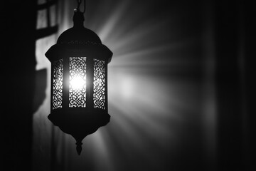 Wall Mural - Lamp with a light shining on it. The light is bright and the lamp is black. The image has a moody and mysterious feel to it