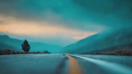 Poster -   A clear photo of a road with a solitary tree on its side and majestic mountains in the backdrop