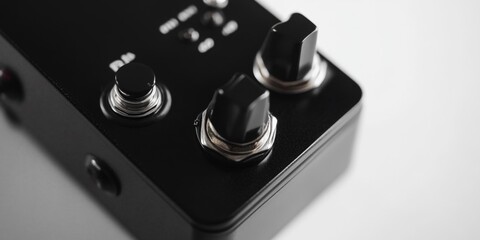 Poster - A detailed view of a guitar pedal on a wooden table, ideal for music-related projects