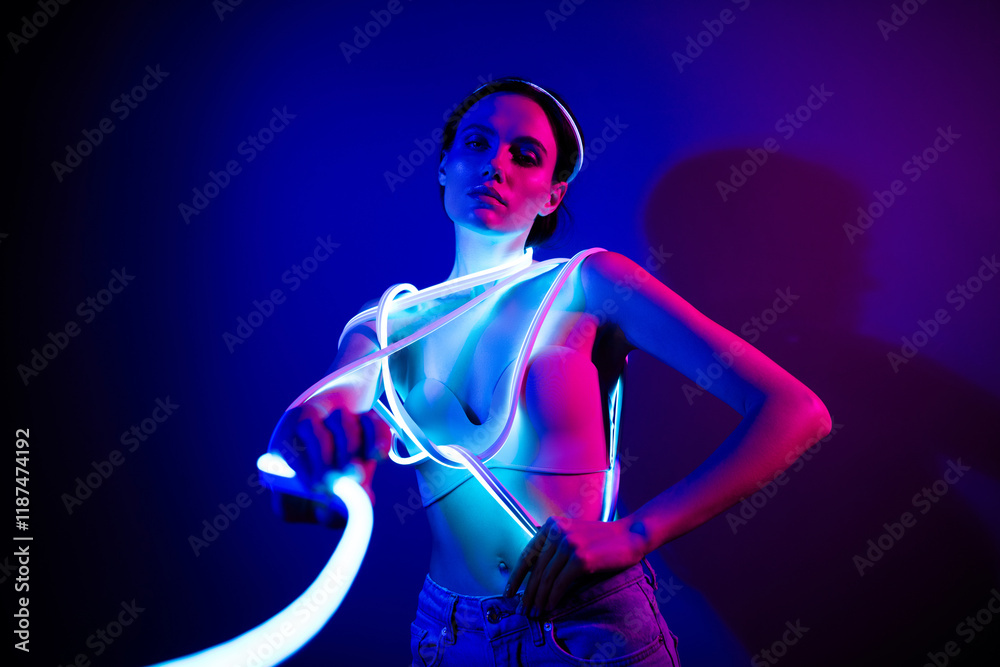 Neon Blue Model Young model in neon glow posing against a dark blue backdrop Stock ...