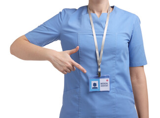 Wall Mural - Medical assistant pointing at her badge on white background, closeup