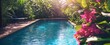 © DZMITRY - A tropical hotel or vacation home in the summer showcases a swimming pool encircled by beautiful flowers, capturing the essence of backyard, garden, landscaping, and design concepts