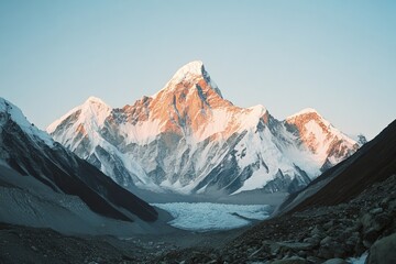 Wall Mural - Majestic snow-covered mountain peak during sunrise