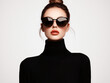© aka_artiom - A Stylish Woman in Sunglasses and a Black Sweater Posed Against a Transparent Background