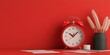 © Ms_Tali - Minimalist red workspace with retro alarm clock and modern decor elements