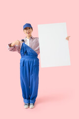 Wall Mural - asian female worker with blank poster on pink background. mockup for design