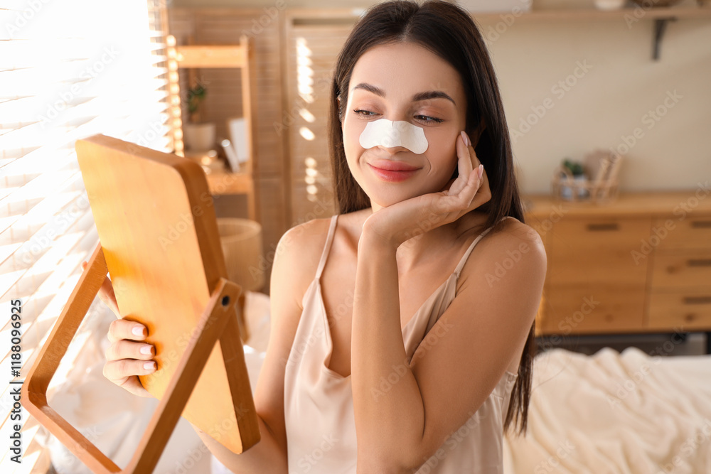 Young woman with nose patch and mirror in bedroom