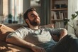 © Anjali - Attractive smiling man relaxing at home