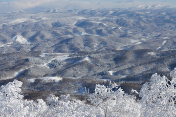 Wall Mural - aerial view of winter mountain landscape with snow in hokkaido, japan