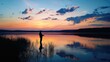 © Kitta Studio - Fisherman Silhouette at Sunset by Tranquil Lake with Colorful Sky