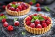 © Pixels Hunter - Delicious raspberry tarts with powdered sugar and mint leaves on dark slate background.