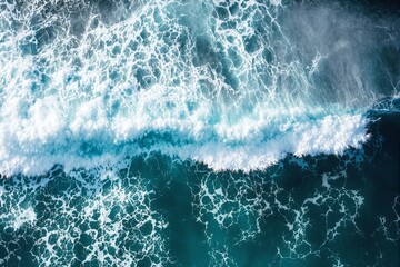 Aufkleber - Aerial view of ocean waves crashing, with white foam patterns and deep teal water in a bright and natural background.