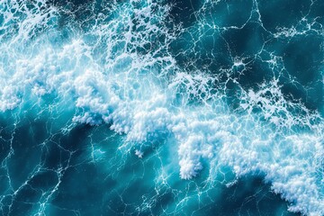 Aufkleber - Aerial view of ocean waves crashing with white foam over vibrant blue water, showcasing dynamic sea patterns.