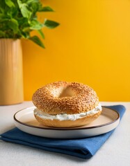 Wall Mural - Sesame bagels with cream cheese on yellow background