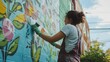 © phy - A volunteer carefully painting a mural on the side of a building, adding beauty and life to the community