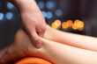 © yanik88 - spa hotel massage therapist gives a relaxing foot massage with massage oil, creating a calming and therapeutic effect. Reflexology foot massage. Foot spa therapist