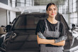 © anatoliycherkas - Portrait of young woman, professional female mechanic smiling at camera standing in auto repair shop. Car service, repair, maintenance and people concept.