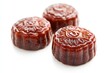 © NASH - Zoomed in view of red Chinese tortoise cakes Ang Ku Kueh on a white backdrop with selective focus Clipping path provided