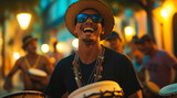 Photographs of happy young men playing hand drums on the street at night, a group with a samba male dancer wearing a black shirt and hat behind them, with light from a lamp post in