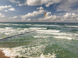 Wall Mural - Kitesurfer riding the big waves at sea. Tourism in Poland.