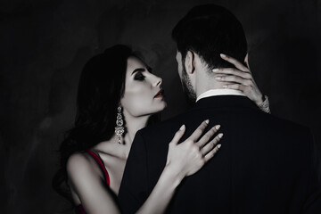 Poster - Dream wish temptation seduction pleasure concept. Charming pretty lady with bijoutery embracing mysterious stranger with rear view enjoying his smell isolated on grey background
